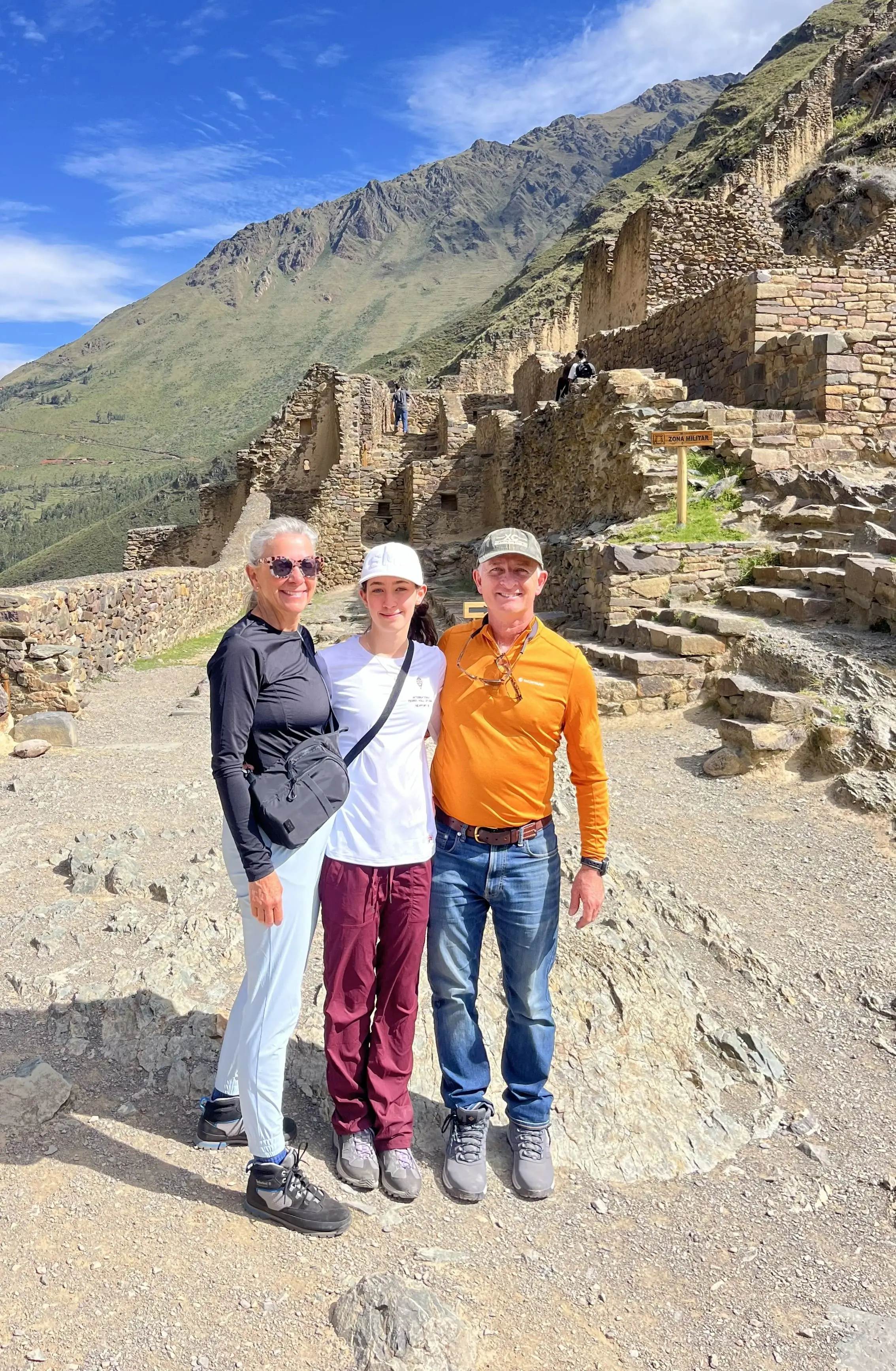Visitors exploring Ollantaytambo archaeological site in Peru