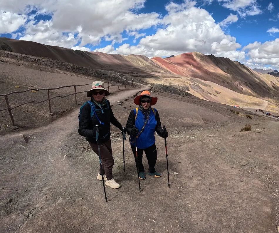 Travelers reaching the summit of Rainbow Mountain Peru