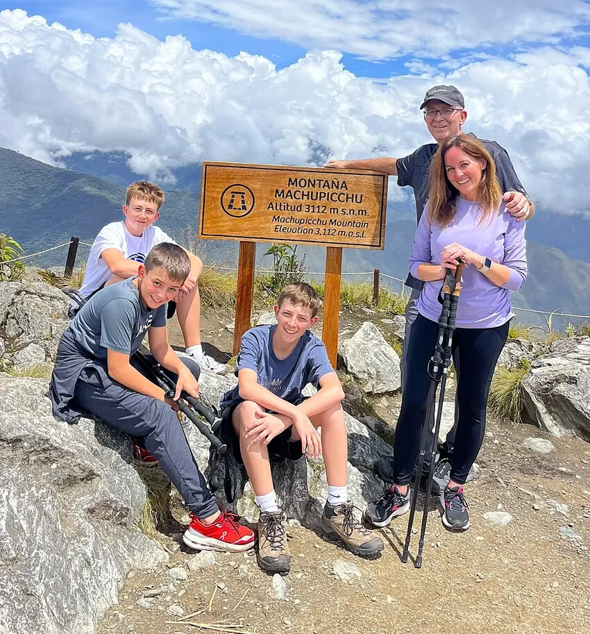 Family enjoying panoramic views from Machu Picchu Mountain Peru